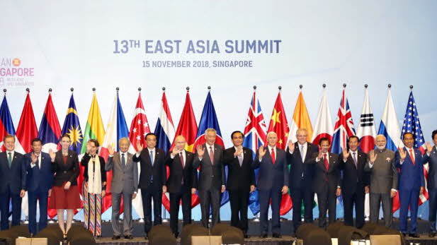 Posing for a group photo at the 13th East Asia Summit held in Singapore