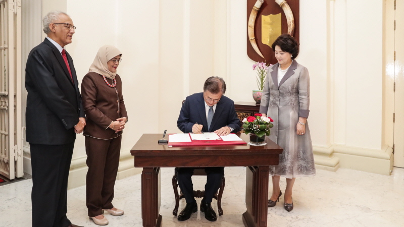 Signing the guestbook at the Istana, the official residence and office of the President of Singapore