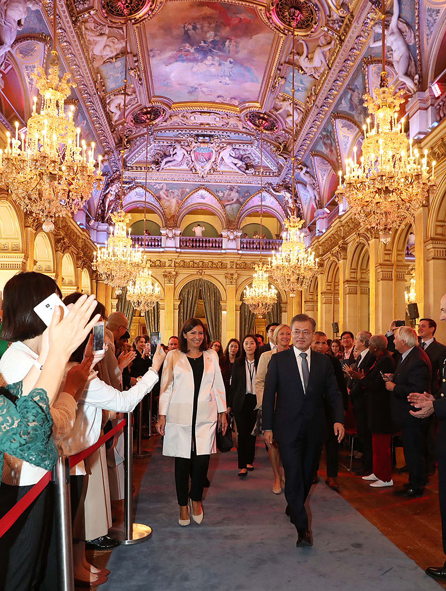 President Moon Jae-in (right) and the Mayor of Paris Anne Hidalgo are greeted by crowds at a welcoming ceremony held in the Salle des Fetes, at the Hotel de Ville in Paris on Oct. 16.