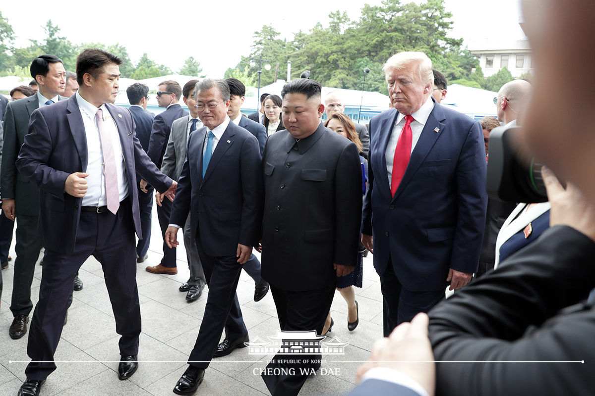 Leaders of the two Koreas and the United States meeting together for the first time in Panmunjeom