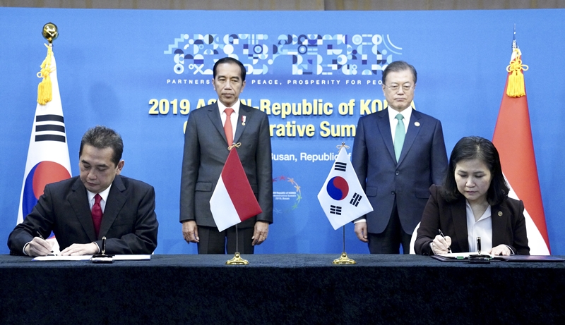 President Moon Jae-in and Indonesian President Joko Widodo on Nov. 25 attend the signing ceremony of a joint declaration on the CEPA between their two nations. Trade Minister Yoo Myung-hee (sitting on the right) and Indonesia's Trade Minister Agus Suparmanto sign the documents with their leaders looking on. 