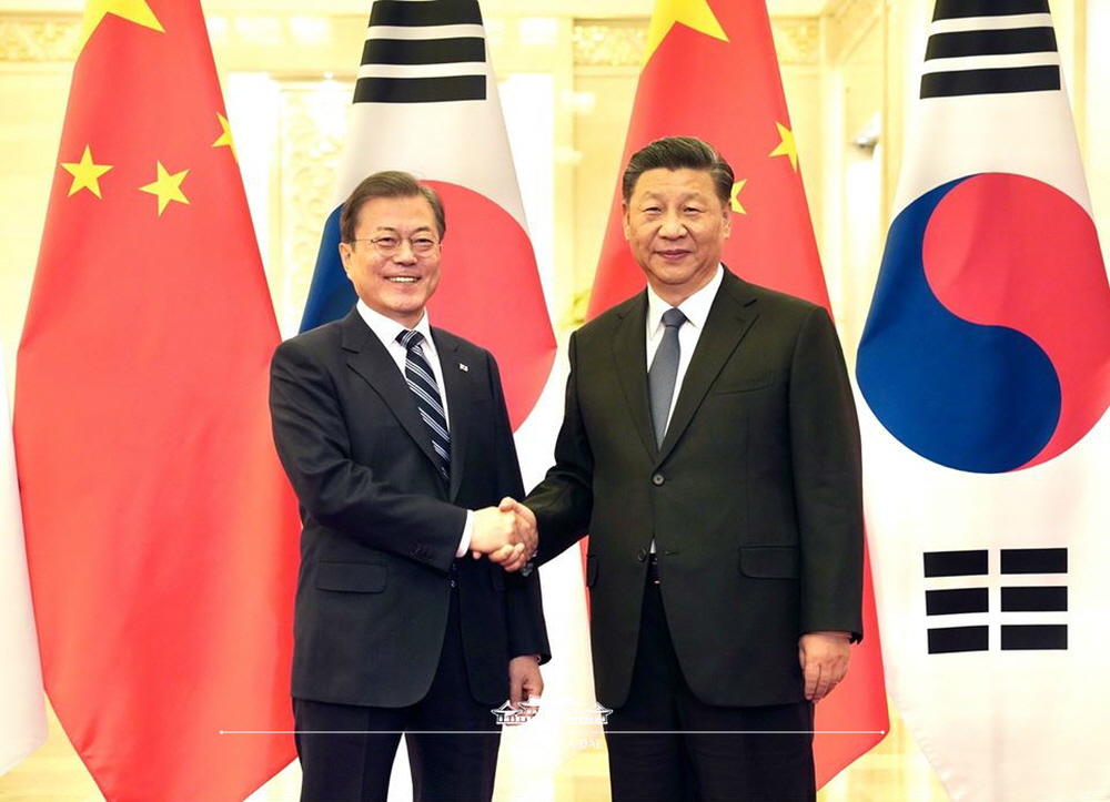 President Moon Jae-in and Chinese President Xi Jinping on Dec. 23 shake hands before holding their bilateral talks at the Great Hall of the People in Beijing, China.