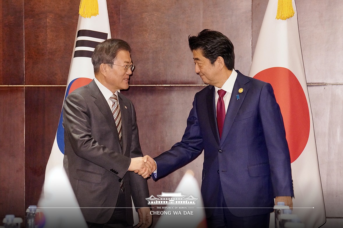 President Moon Jae-in on Dec. 24 shakes hands with Japanese Prime Minister Shinzo Abe before their bilateral summit at the Shangri-La Hotel in Chengdu, China.