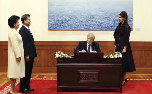 Signing the guestbook and taking commemorative photos to mark the state visit by U.S. President Donald Trump